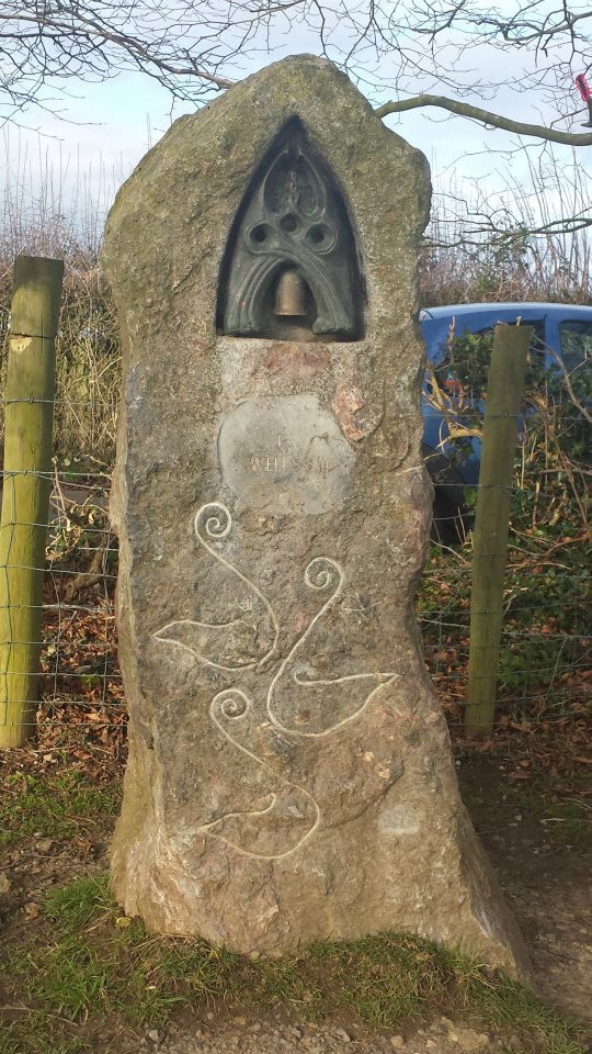 Millennium stone at the base of Glastonbury Tor (Moneybox Field). The stone also serves as a milestone — Wells is eight miles away. 